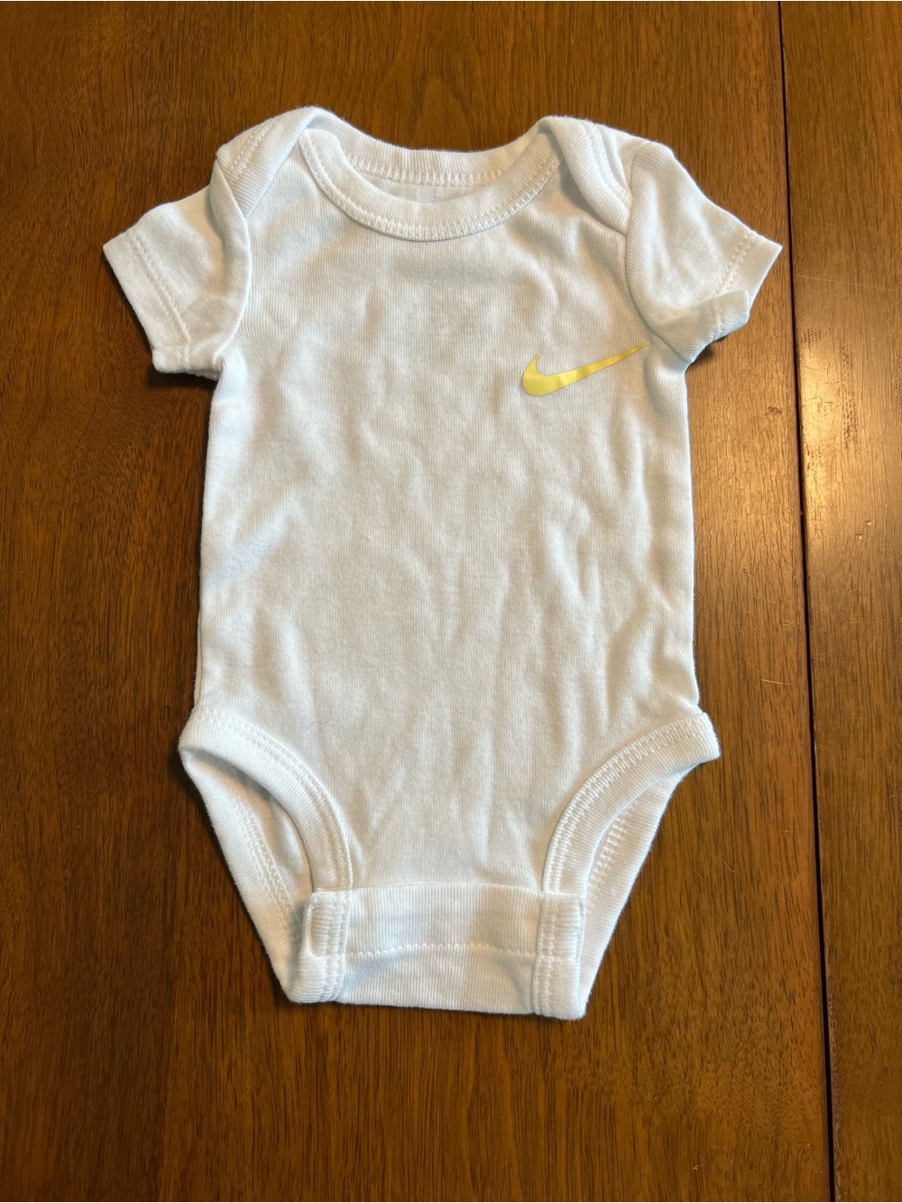 Nike White Baby Bodysuit with Yellow Swoosh